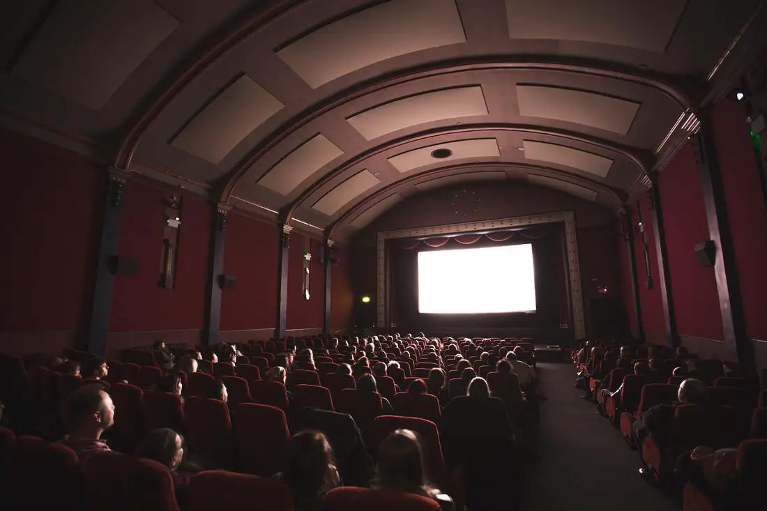 photo of people watching a movie at a movie theater